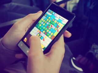 A person playing a game on a cellphoneDescription automatically generated